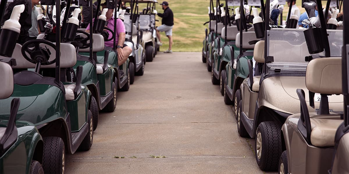 Rows of golf carts assembled for leagues, tournaments, and group outings at Crooked Creek Golf Club before tee-off.