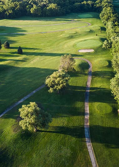 Aerial view of Crooked Creek Golf Club featuring tree-lined fairways, manicured rough, a winding cart path, and strategically placed bunkers.