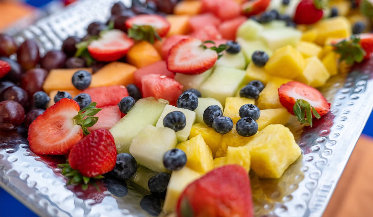 Fresh fruit appetizer display featuring strawberries, blueberries, grapes, melon, and pineapple, served for events at Crooked Creek Golf Club.